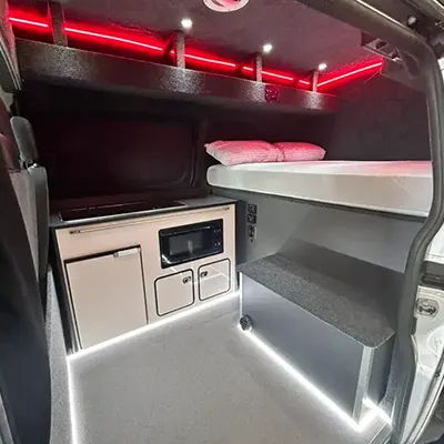 The interior of a vehicle with a stove and oven.