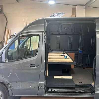A van with a table in the back of it.